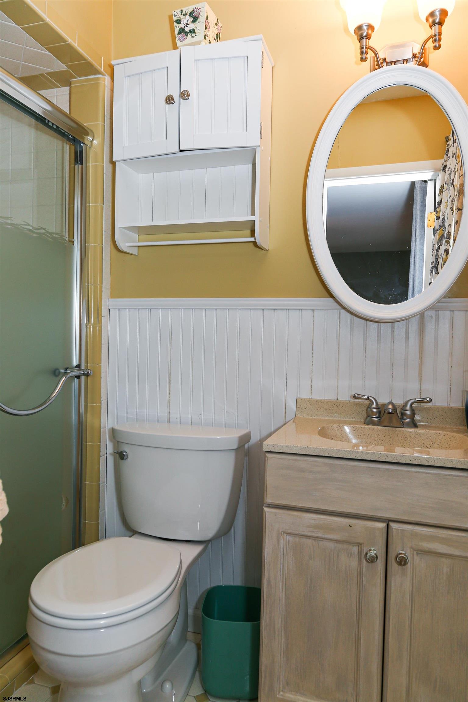5216 Waterview Drive Brigantine, NJ 08203 - Photo 14 of 57 a bathroom with a toilet sink vanity and mirror