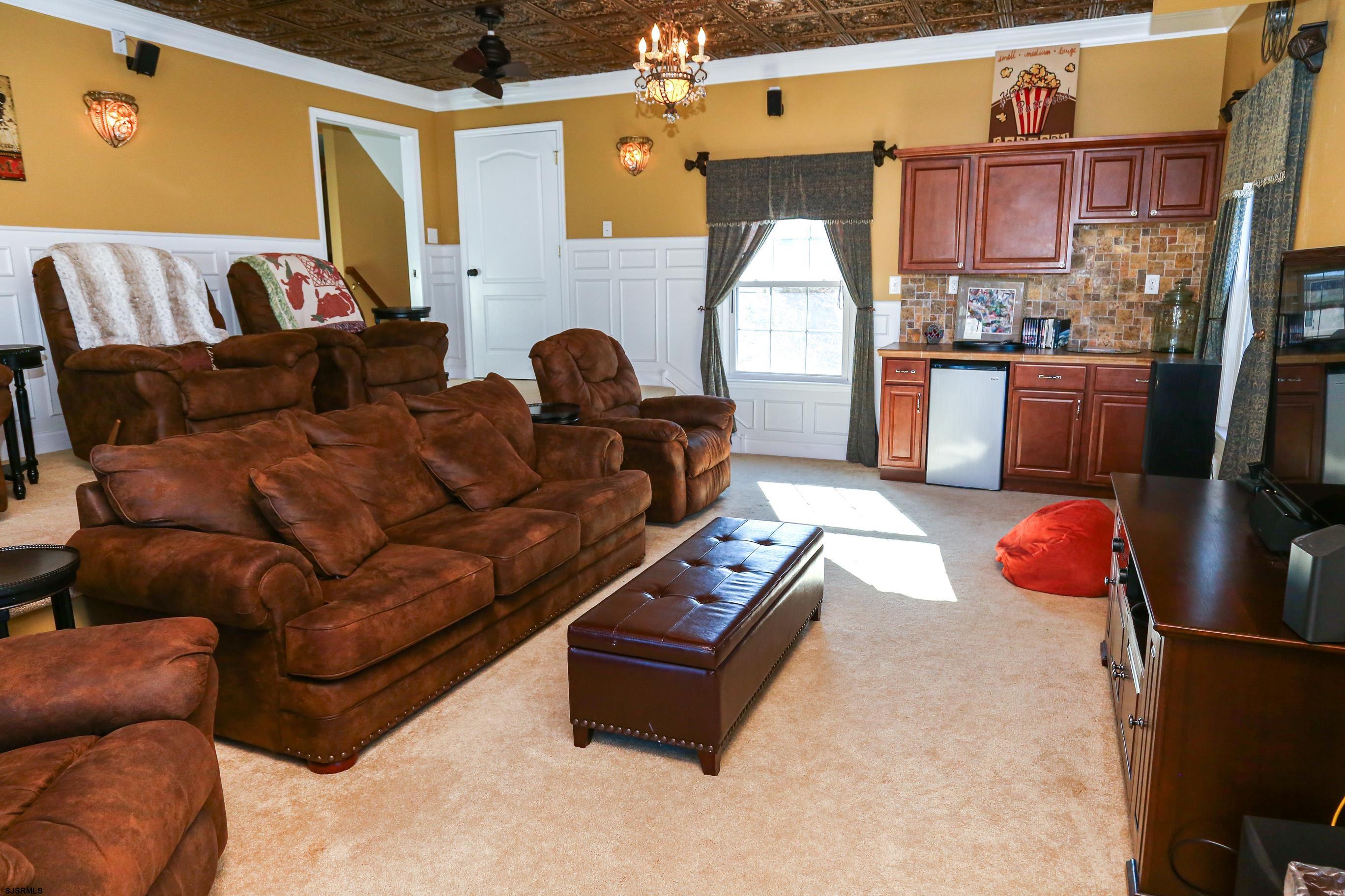 5216 Waterview Drive Brigantine, NJ 08203 - Photo 19 of 57 a living room with furniture fireplace and a flat screen tv