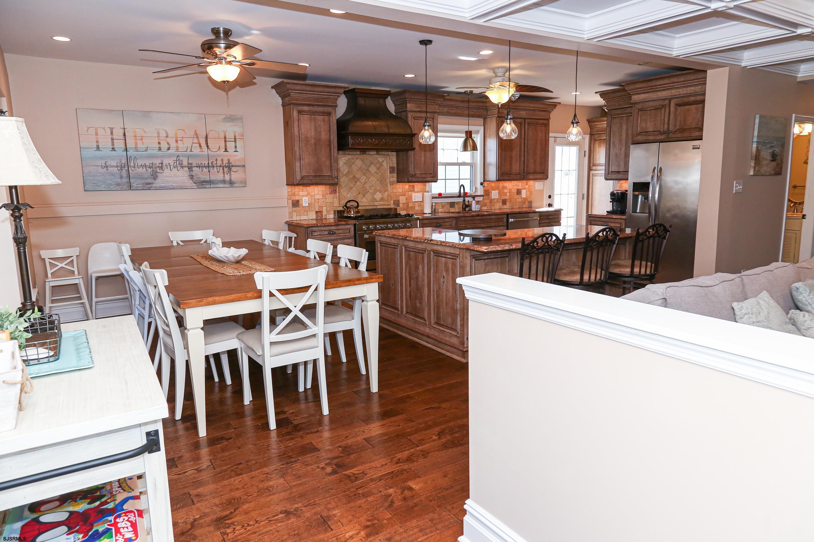 5216 Waterview Drive Brigantine, NJ 08203 - Photo 22 of 57 a kitchen with a dining table chairs and white appliances