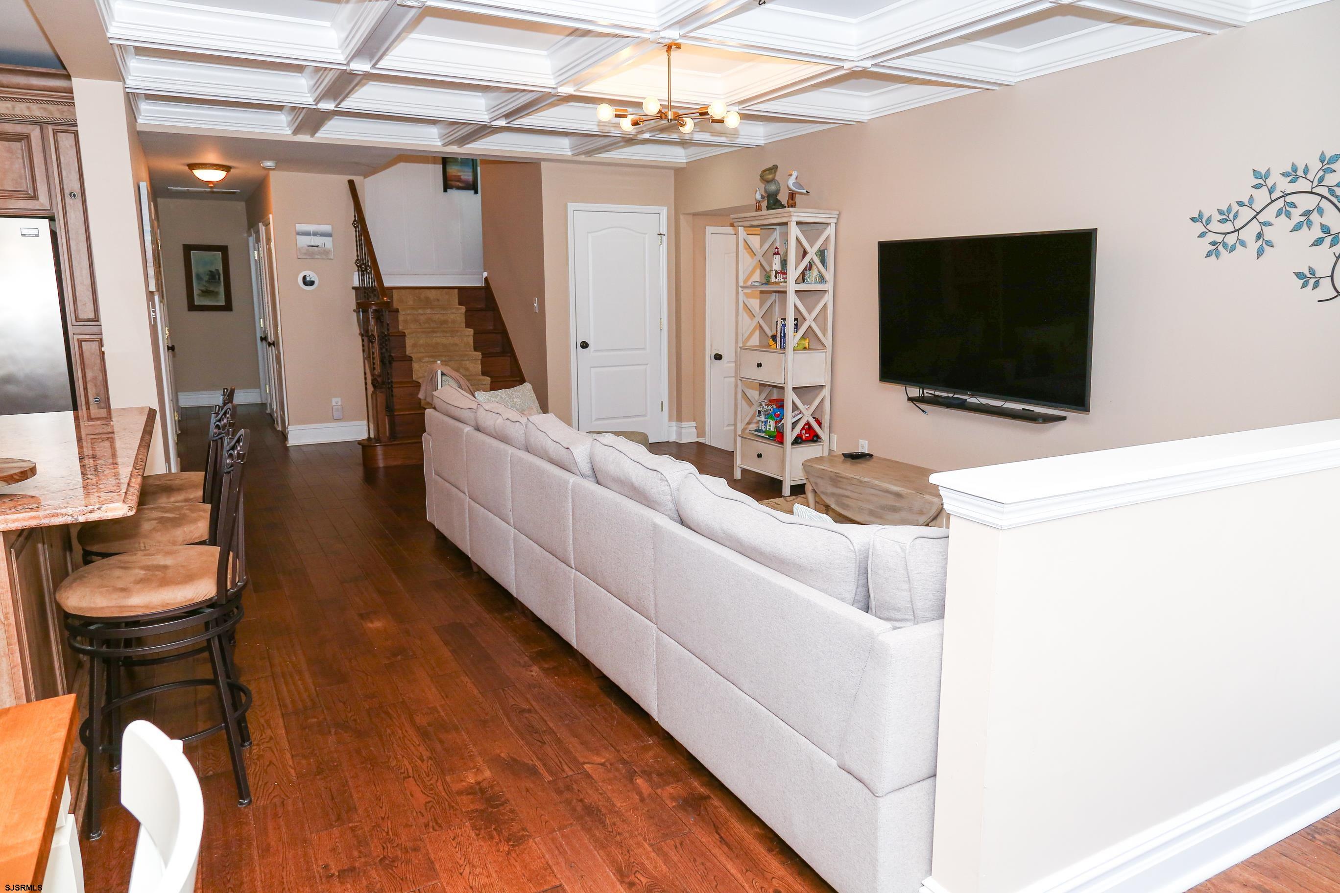 5216 Waterview Drive Brigantine, NJ 08203 - Photo 26 of 57 a living room with furniture and a flat screen tv