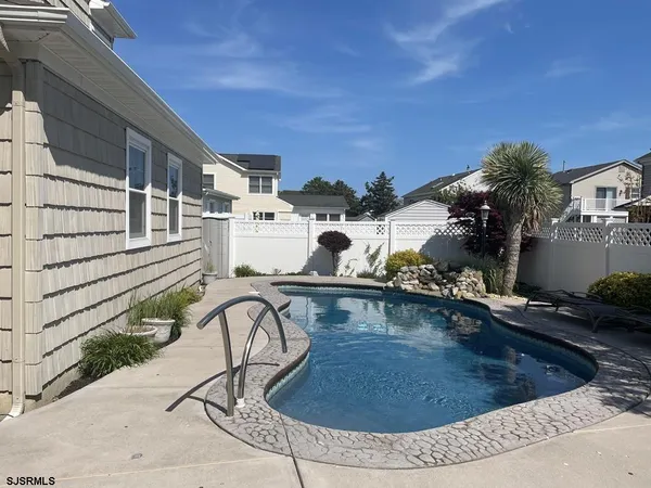 a view of a swimming pool with sitting area
