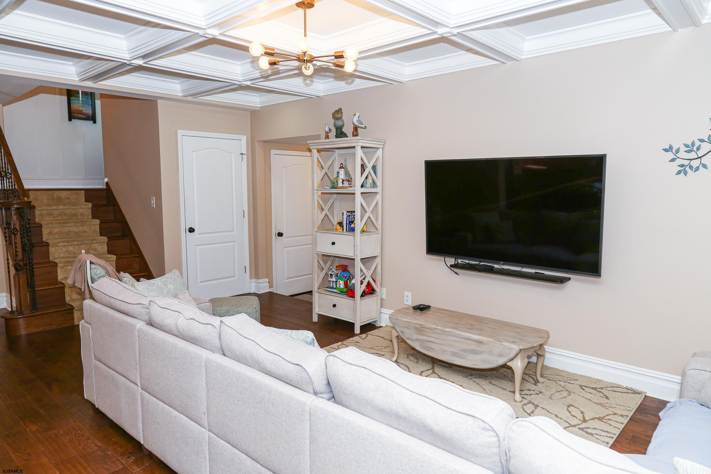 5216 Waterview Drive Brigantine, NJ 08203 - Photo 42 of 57 a living room with furniture and a flat screen tv