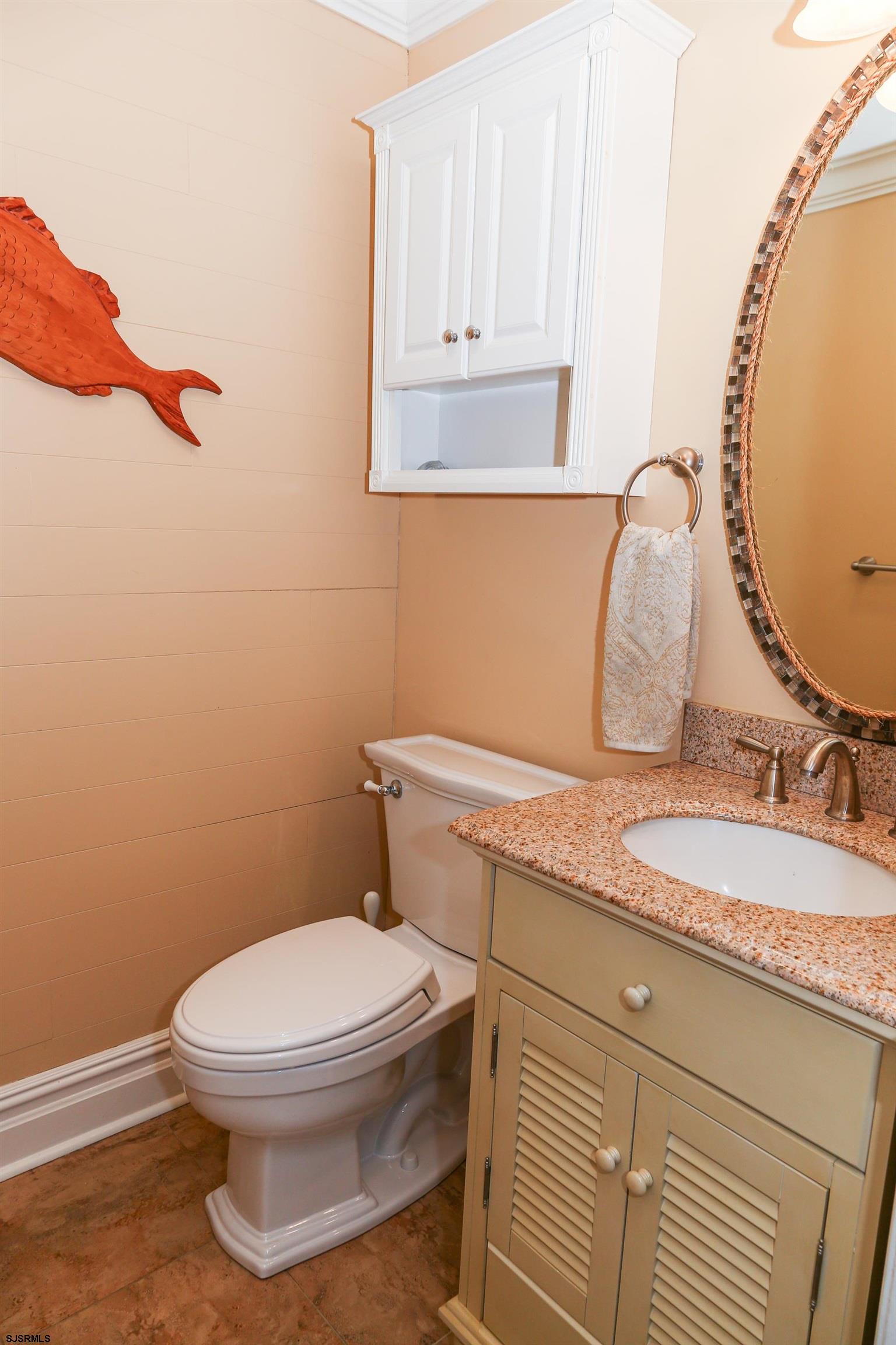 5216 Waterview Drive Brigantine, NJ 08203 - Photo 43 of 57 a bathroom with a granite countertop toilet sink and mirror
