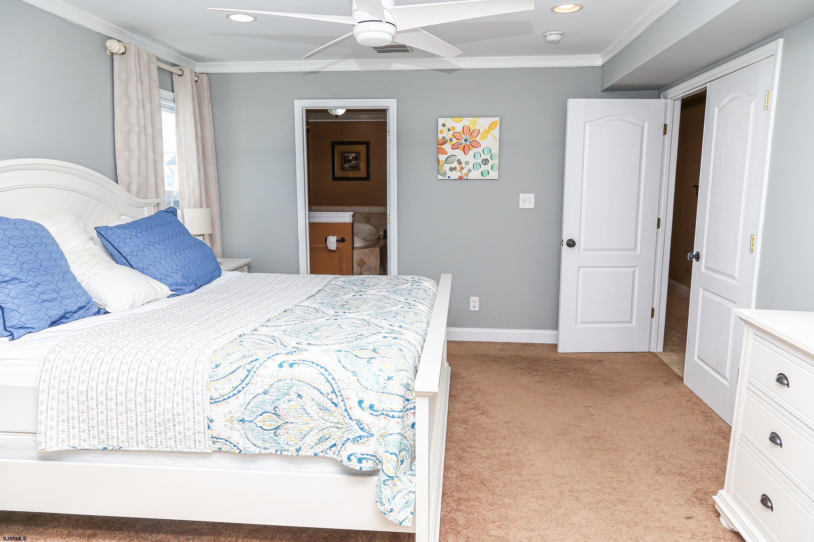 5216 Waterview Drive Brigantine, NJ 08203 - Photo 46 of 57 a bedroom with a bed and a painting on the wall