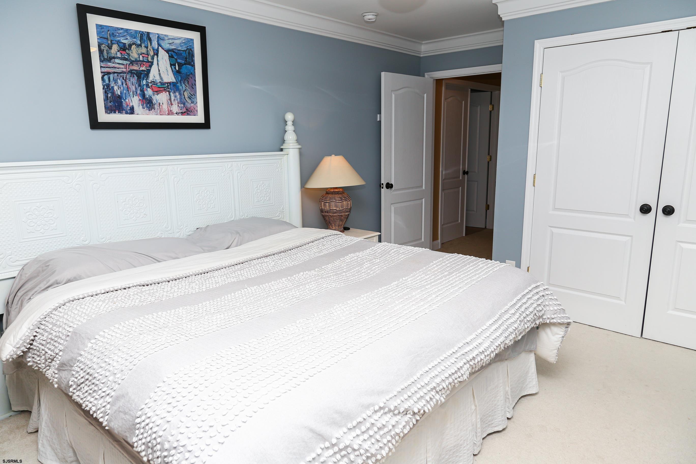 5216 Waterview Drive Brigantine, NJ 08203 - Photo 51 of 57 a bed sitting in a bedroom and painting on the wall