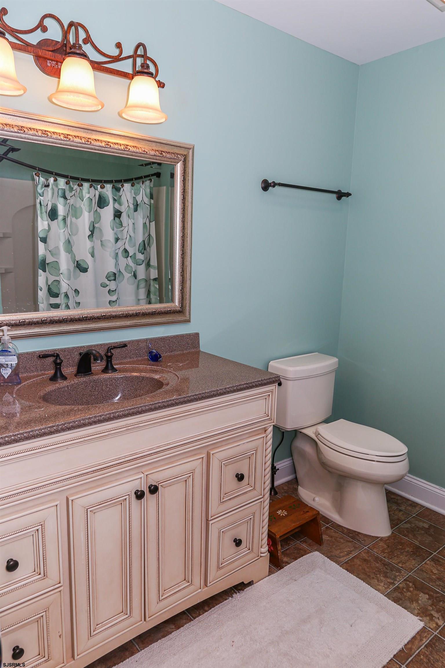 5216 Waterview Drive Brigantine, NJ 08203 - Photo 9 of 57 a bathroom with a toilet a sink and vanity