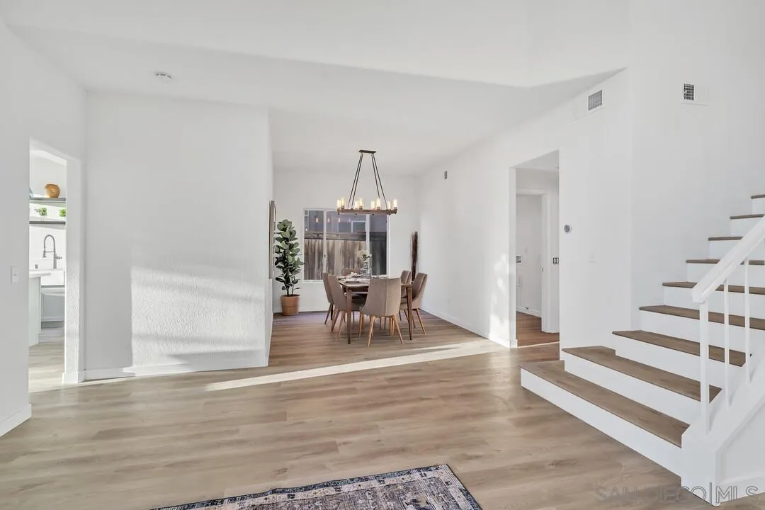 1518 Corte Roberto Oceanside, CA 92056 - Photo 13 of 41 a living room with furniture and a chandelier