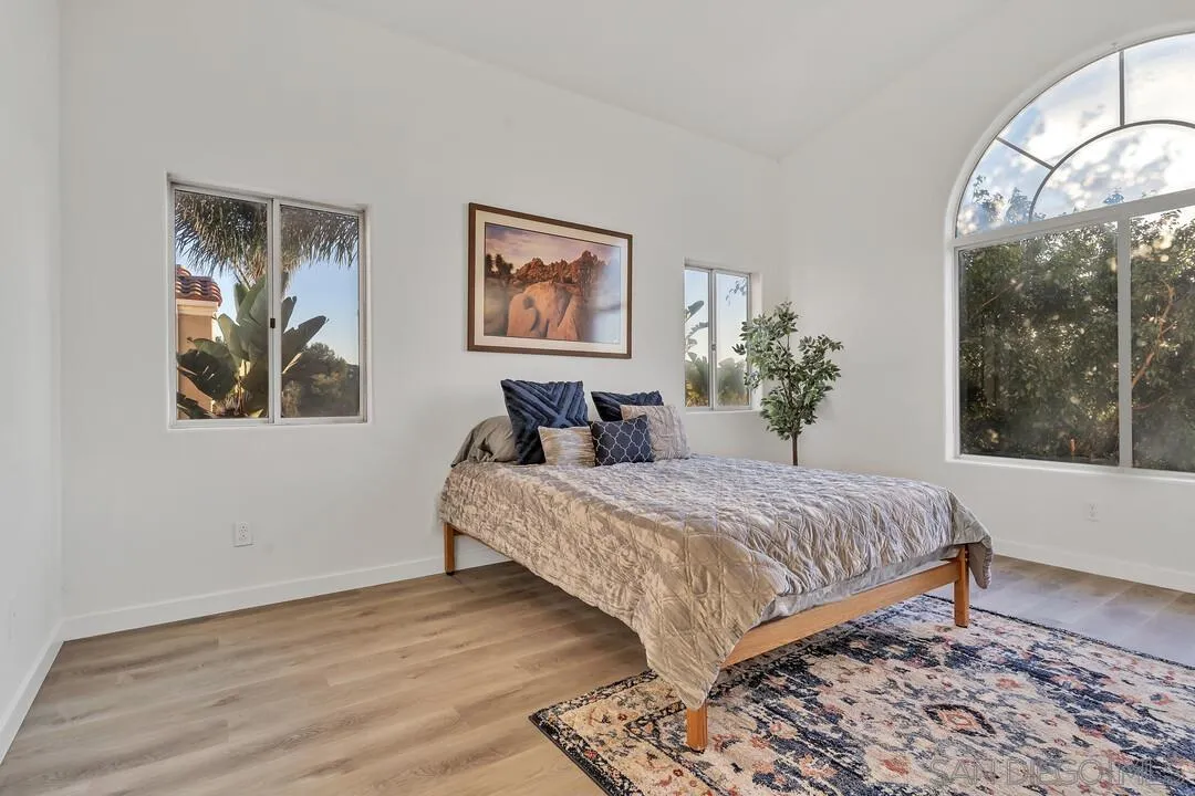 1518 Corte Roberto Oceanside, CA 92056 - Photo 18 of 41 a bedroom with a bed and a painting on the wall