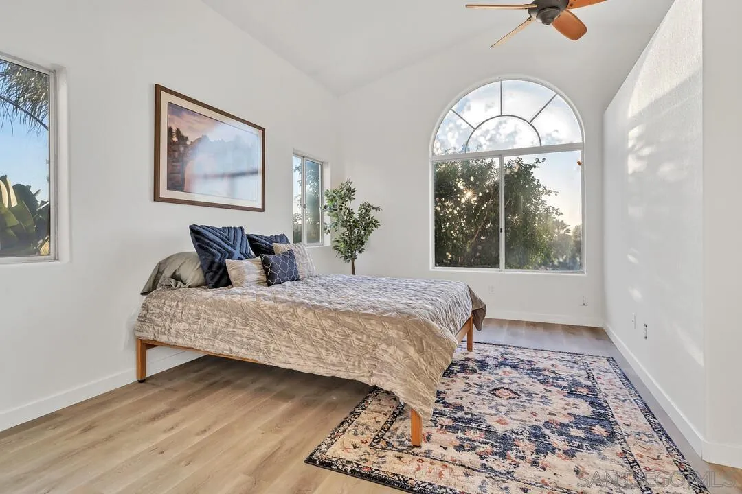 1518 Corte Roberto Oceanside, CA 92056 - Photo 19 of 41 a bedroom with a large bed and a window