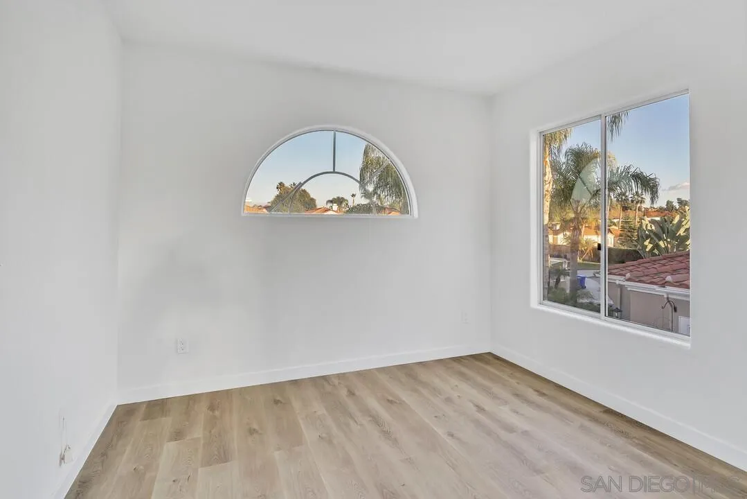 1518 Corte Roberto Oceanside, CA 92056 - Photo 26 of 41 an empty room with wooden floor and window