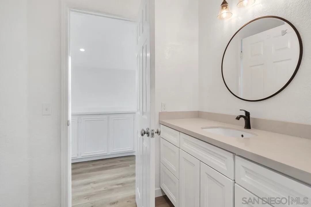 1518 Corte Roberto Oceanside, CA 92056 - Photo 30 of 41 a bathroom with a sink and a mirror