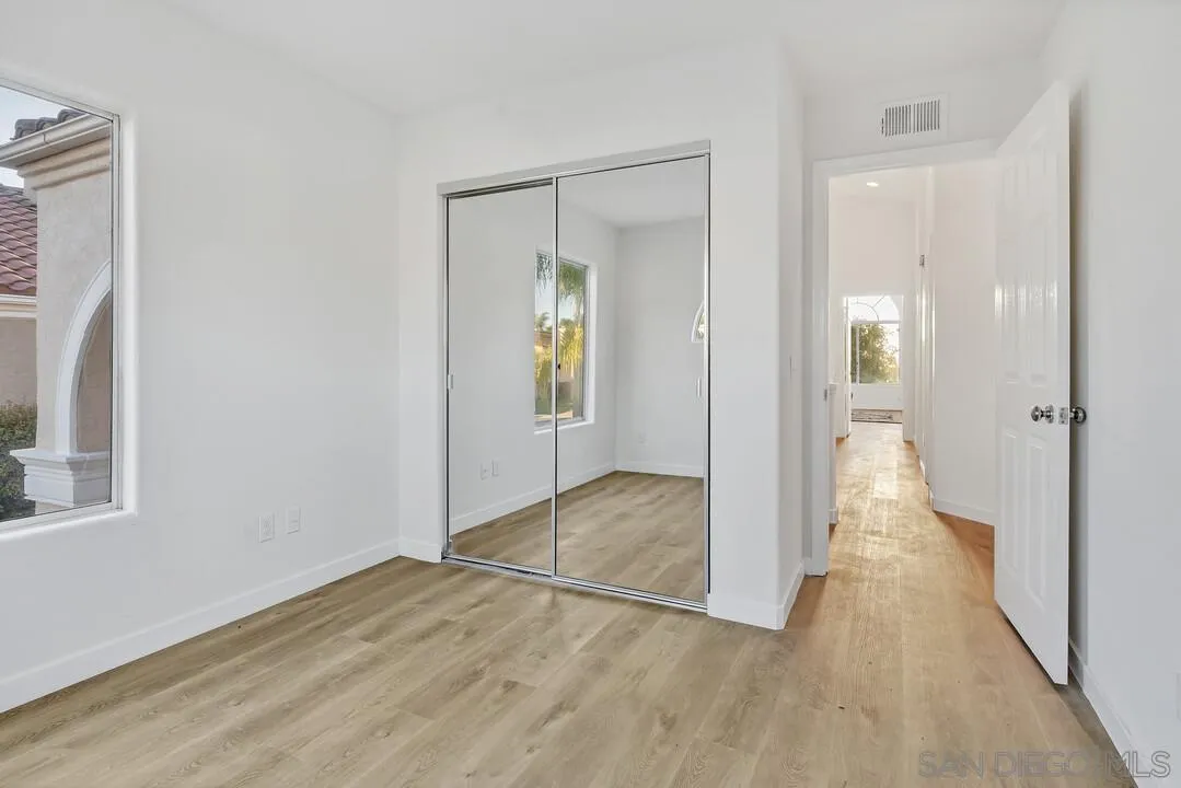 1518 Corte Roberto Oceanside, CA 92056 - Photo 31 of 41 a view of a hallway with wooden floor and a bathroom