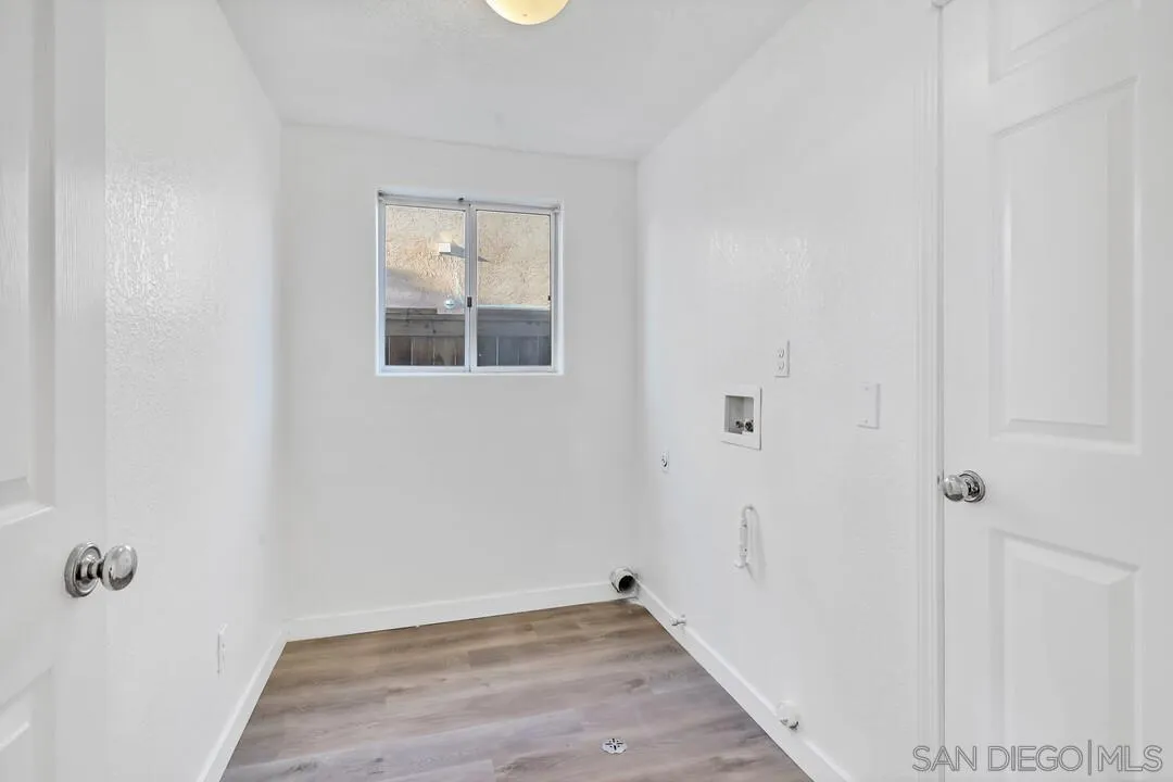 1518 Corte Roberto Oceanside, CA 92056 - Photo 34 of 41 a view of an empty room with wooden floor and a window