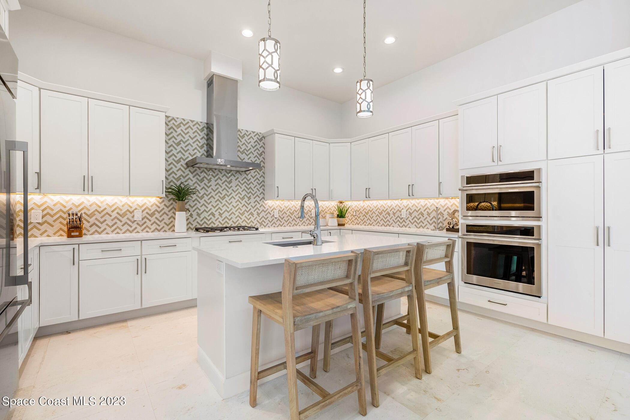 Undisclosed Address Vero Beach, FL 32963 - Photo 14 of 36 a kitchen with kitchen island granite countertop a table and chairs in it