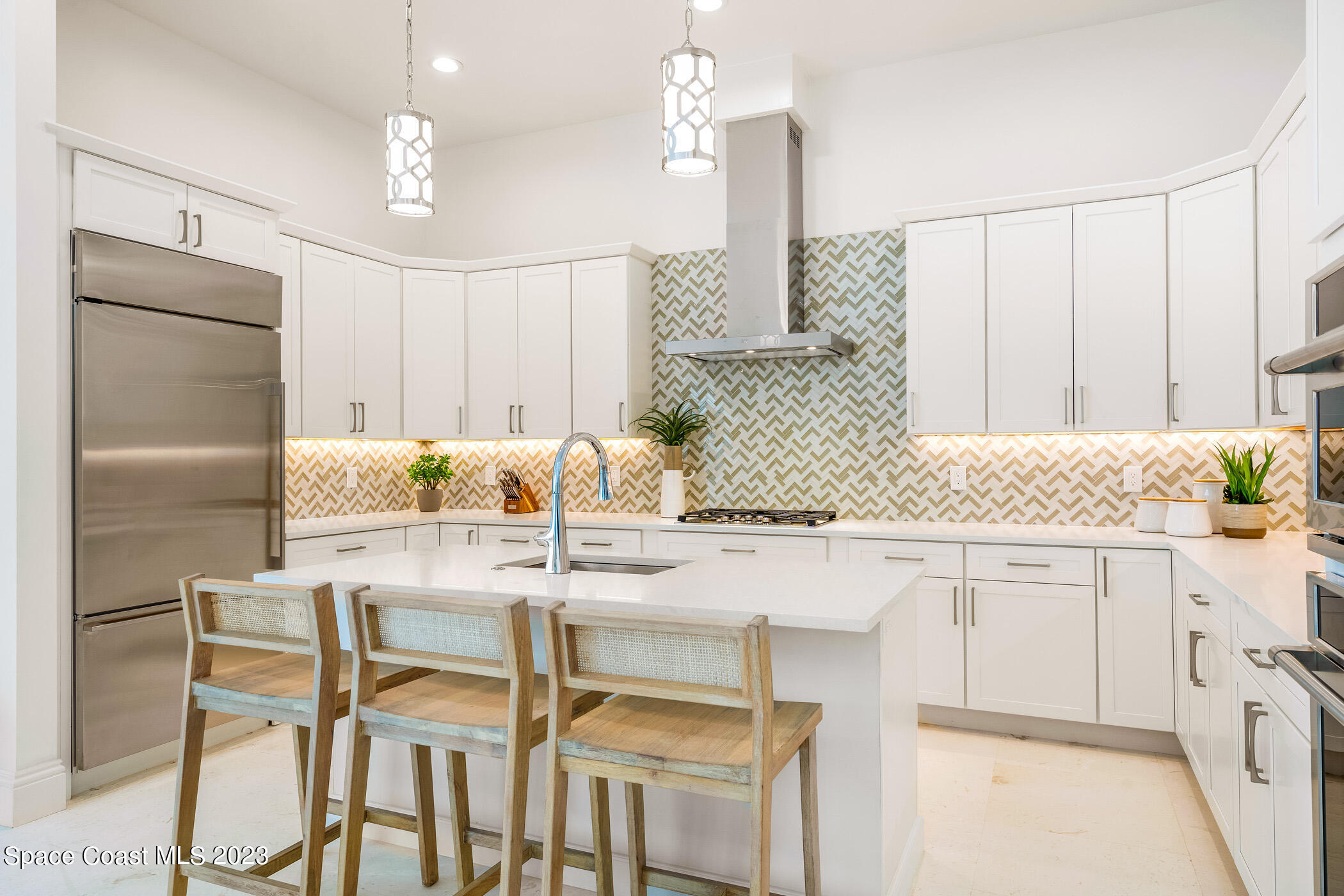 Undisclosed Address Vero Beach, FL 32963 - Photo 10 of 36 a kitchen with granite countertop white cabinets and stainless steel appliances