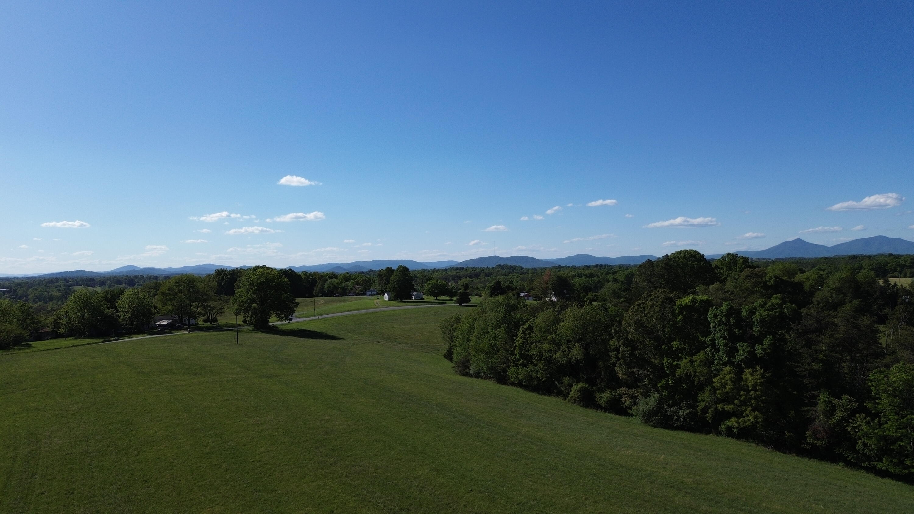 2556 Rock Cliff Road Bedford, VA 24523 - Photo 19 of 35 a view of a grassy field with trees