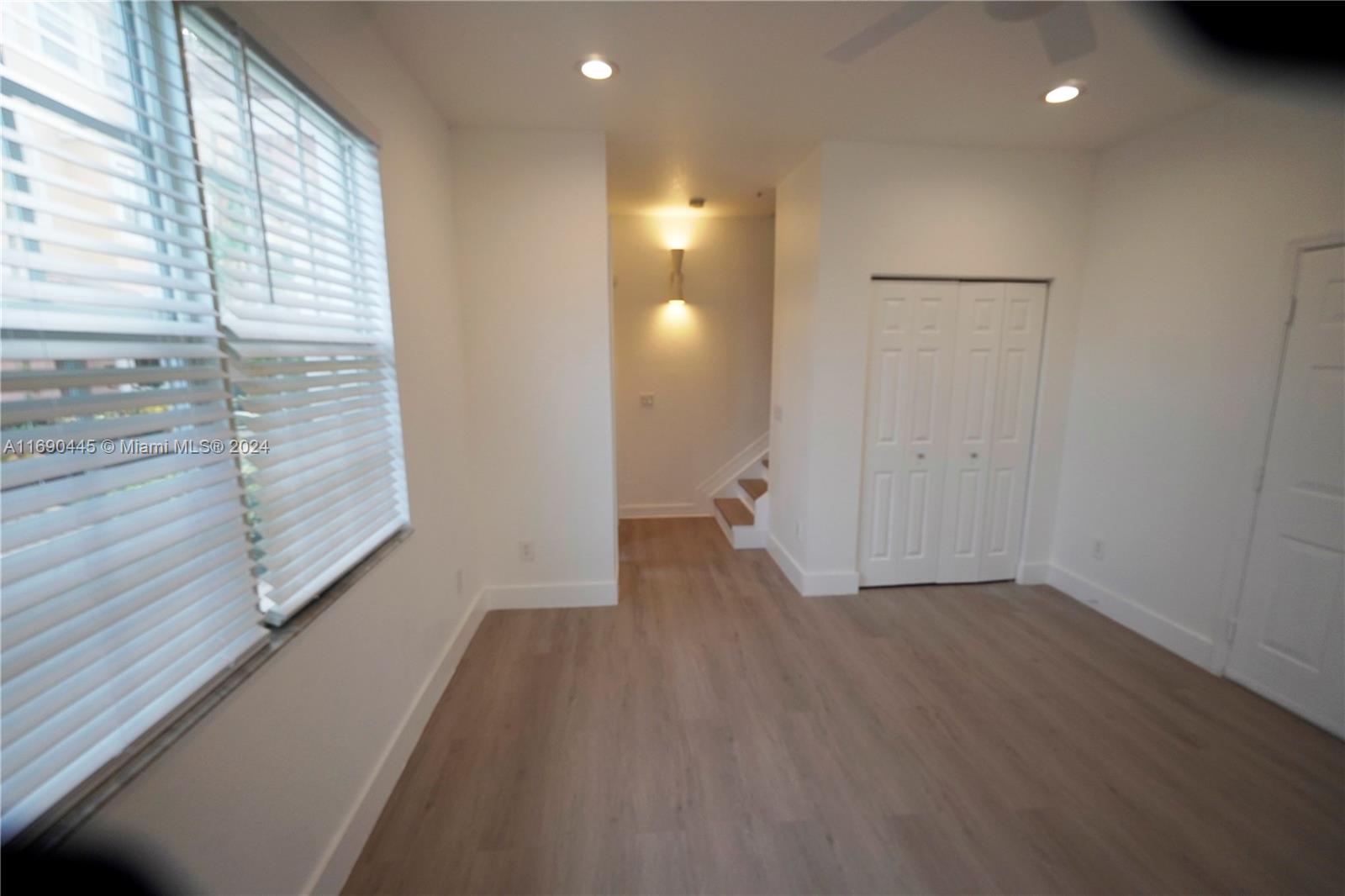 123 Harbors Way Boynton Beach, FL 33435 - Photo 11 of 38 a view of hallway with stairs and wooden floor