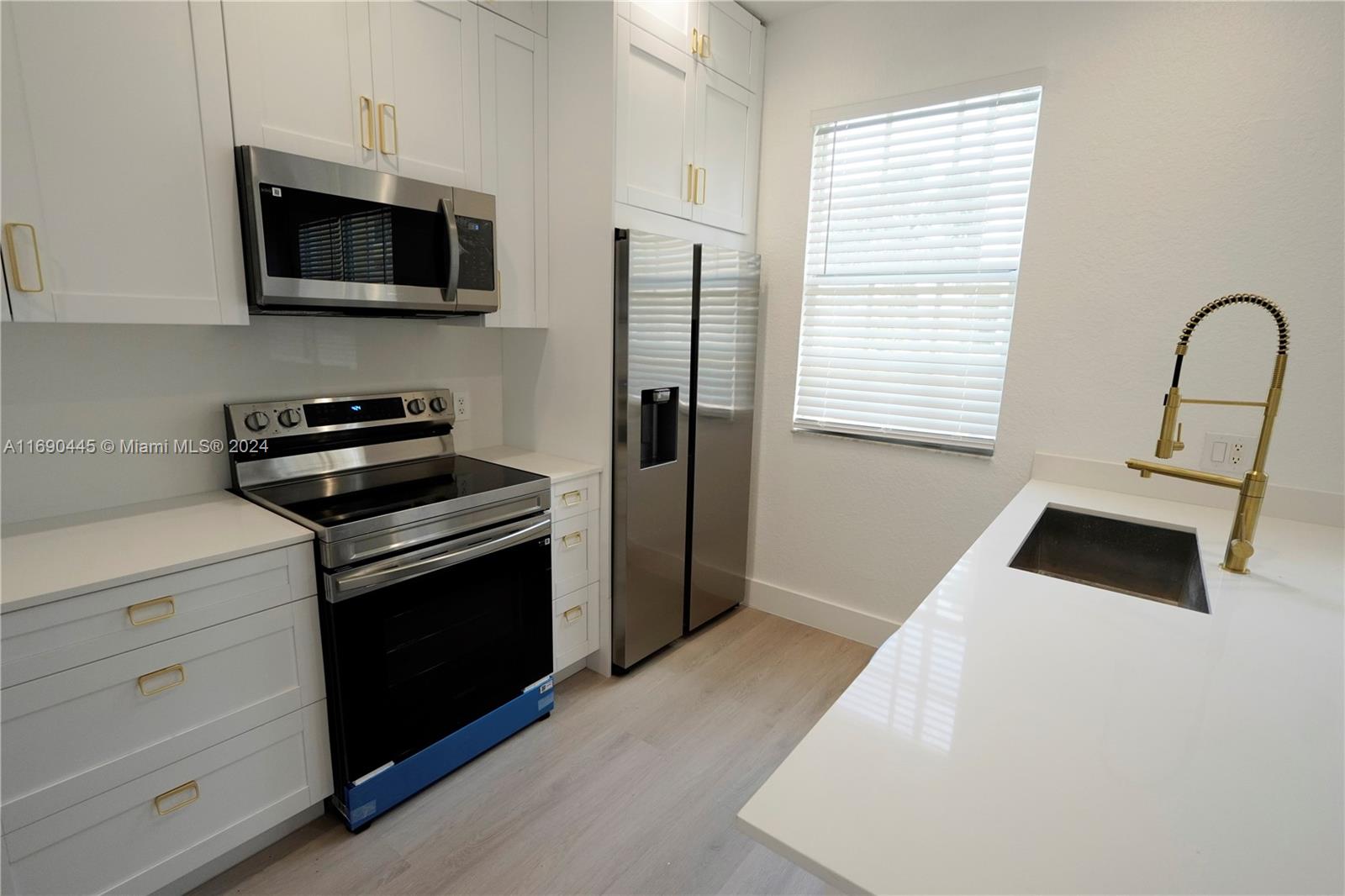 123 Harbors Way Boynton Beach, FL 33435 - Photo 16 of 38 a kitchen with stainless steel appliances a stove microwave and a refrigerator