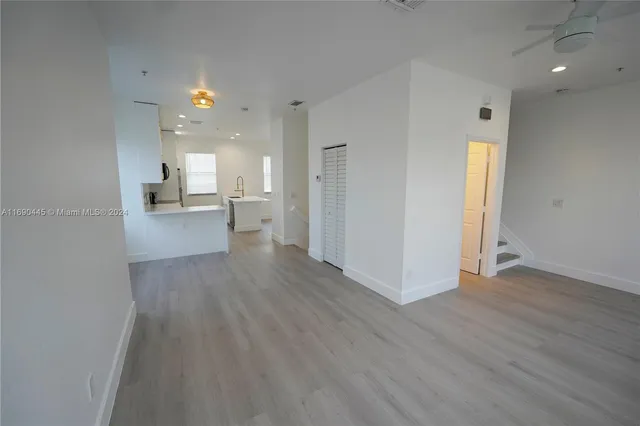 a view of entryway and hall with wooden floor