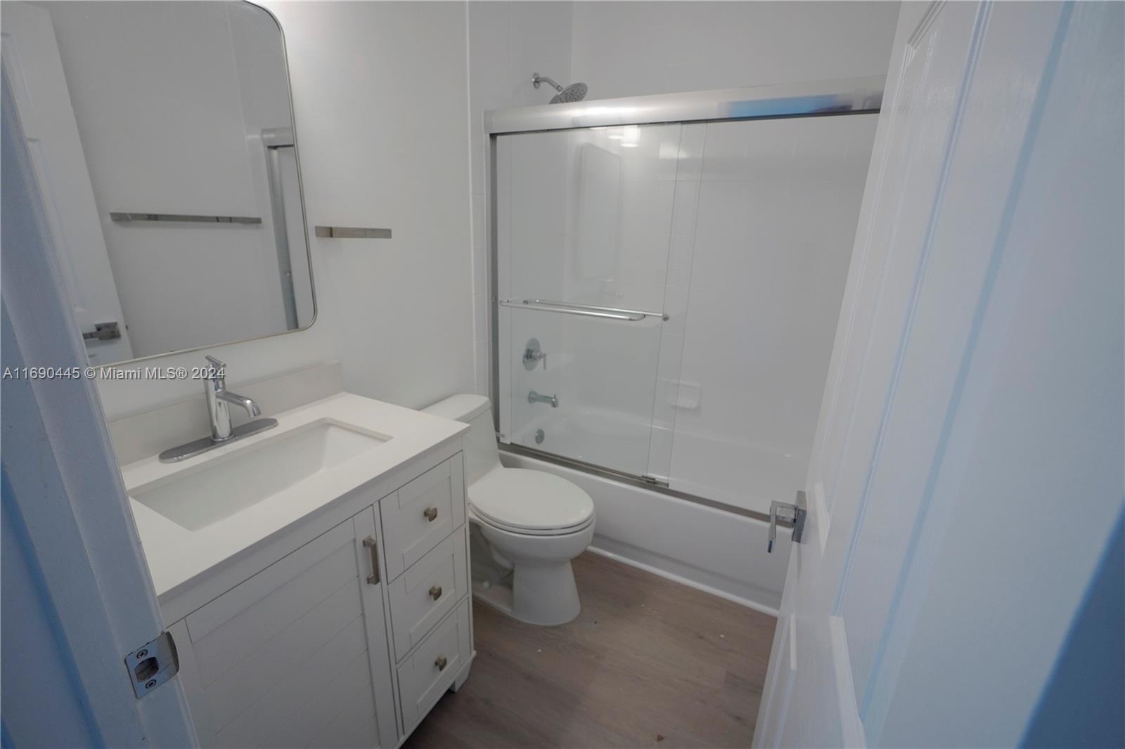123 Harbors Way Boynton Beach, FL 33435 - Photo 22 of 38 a bathroom with a granite countertop sink toilet and shower
