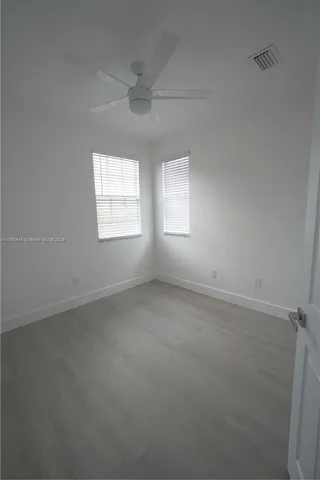a view of an empty room with closet area