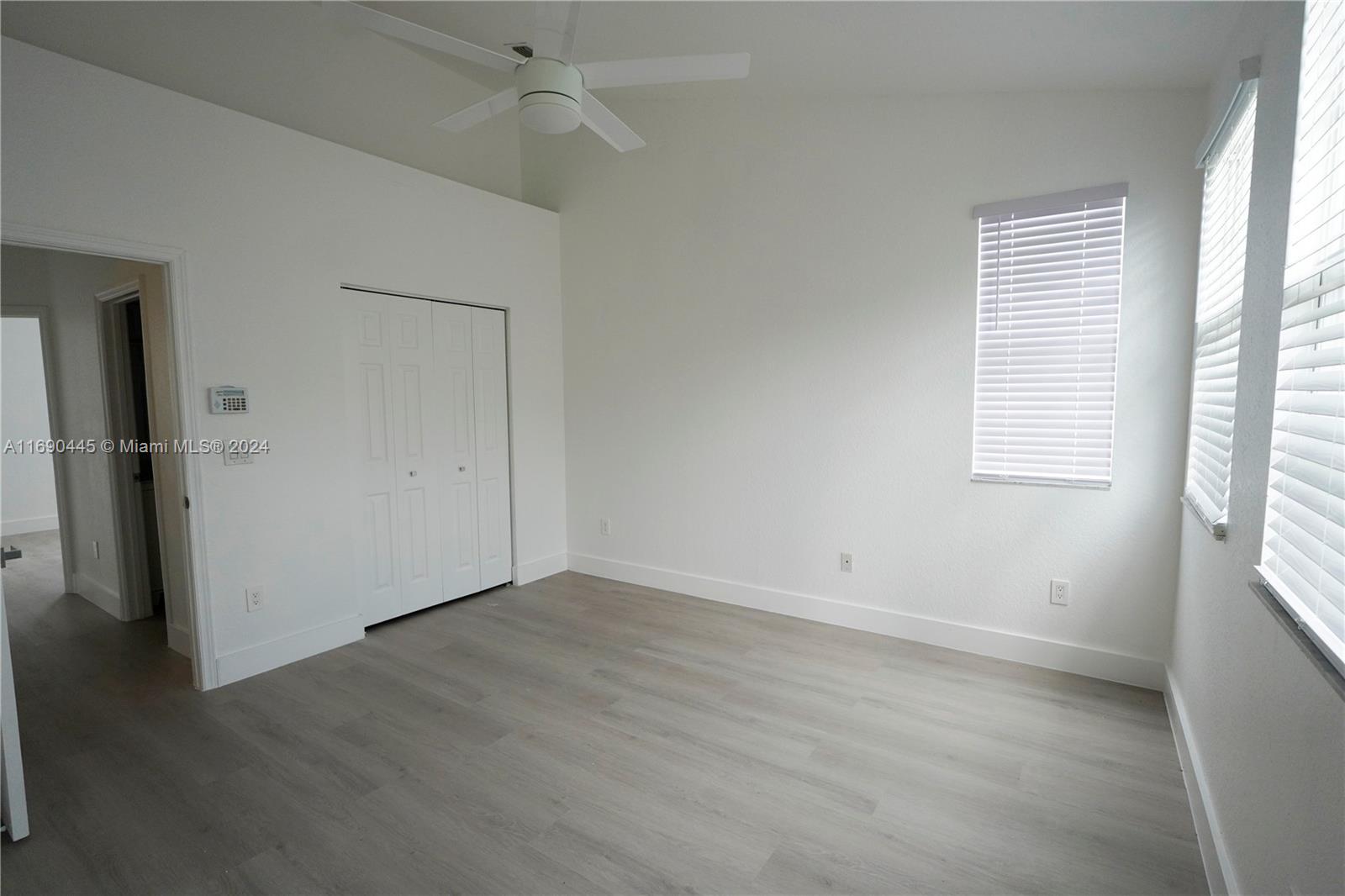 123 Harbors Way Boynton Beach, FL 33435 - Photo 29 of 38 an empty room with wooden floor and windows