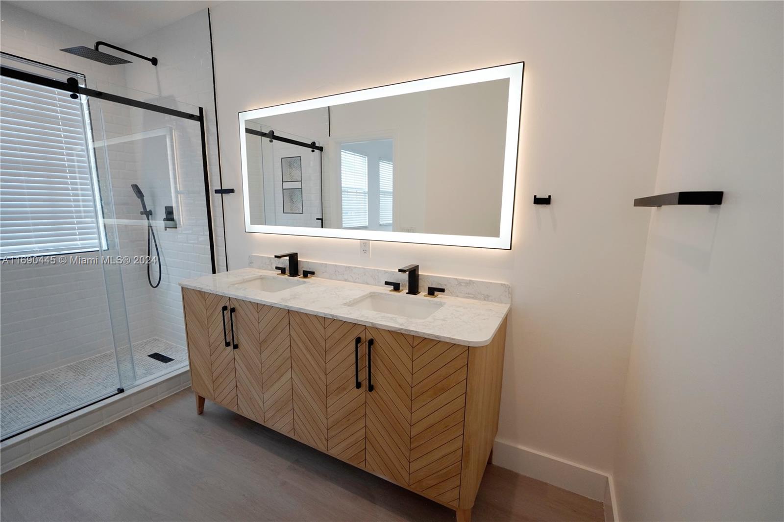 123 Harbors Way Boynton Beach, FL 33435 - Photo 32 of 38 a bathroom with a sink a mirror and a shower