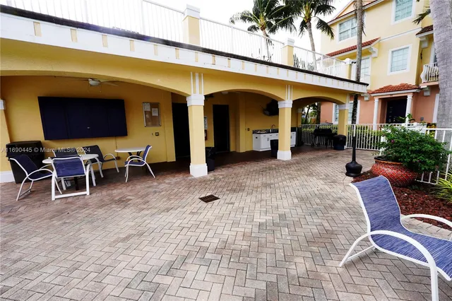 a view of a balcony with table and chairs