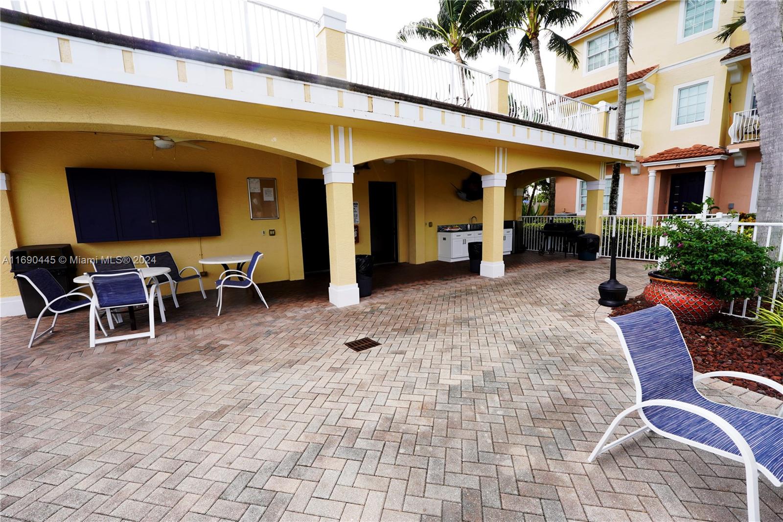 123 Harbors Way Boynton Beach, FL 33435 - Photo 37 of 38 a view of a patio with table and chairs near a barbeque