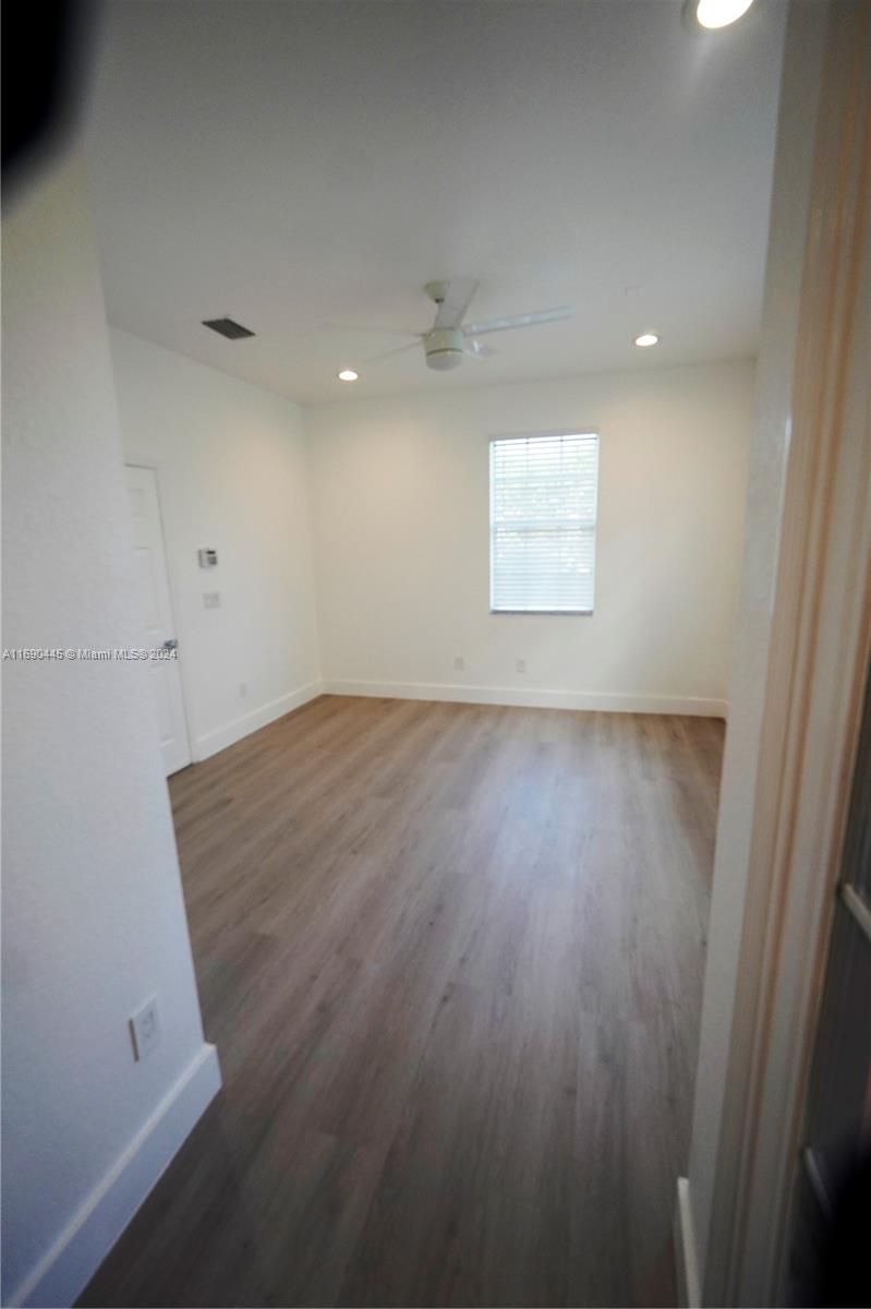 123 Harbors Way Boynton Beach, FL 33435 - Photo 10 of 38 an empty room with wooden floor and windows