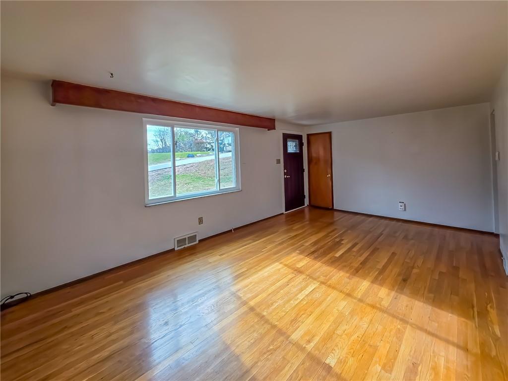 1494 Blossom Hill Road Pittsburgh, PA 15234 - Photo 11 of 40 a view of an empty room with wooden floor and a window