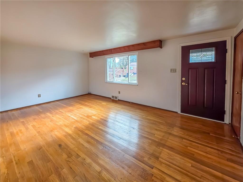 1494 Blossom Hill Road Pittsburgh, PA 15234 - Photo 12 of 40 a view of an empty room with wooden floor and a window
