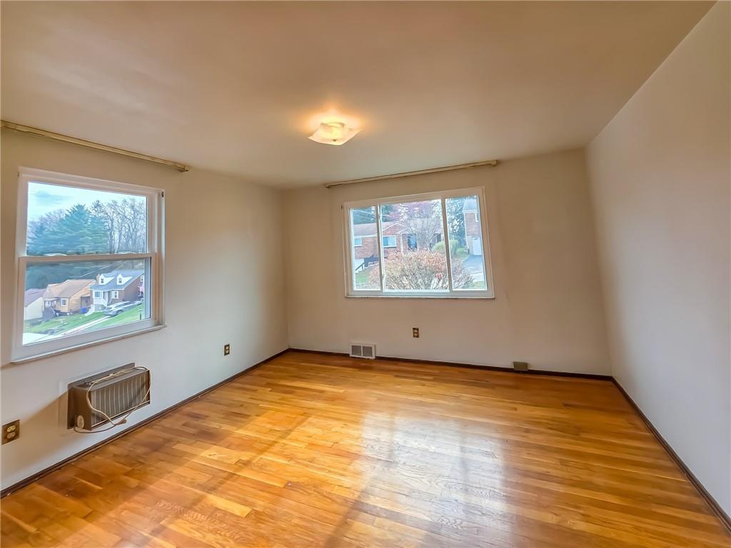 1494 Blossom Hill Road Pittsburgh, PA 15234 - Photo 14 of 40 a view of an empty room with wooden floor and a window