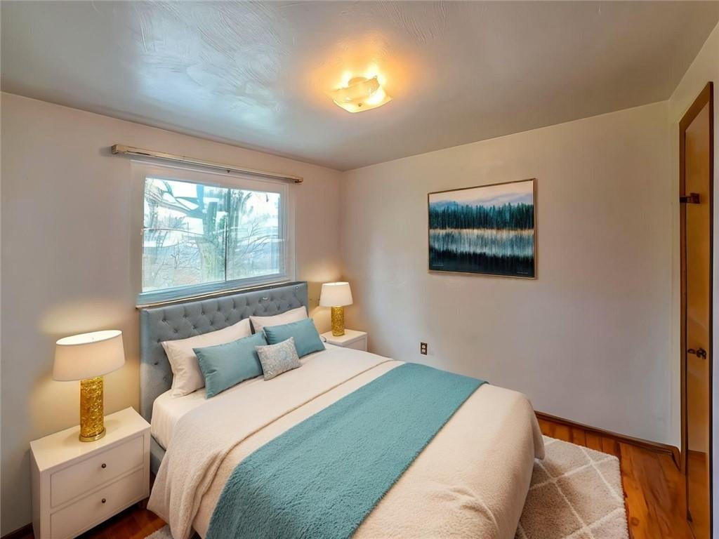 1494 Blossom Hill Road Pittsburgh, PA 15234 - Photo 16 of 40 a bedroom with a bed and a lamp on dresser next to a window