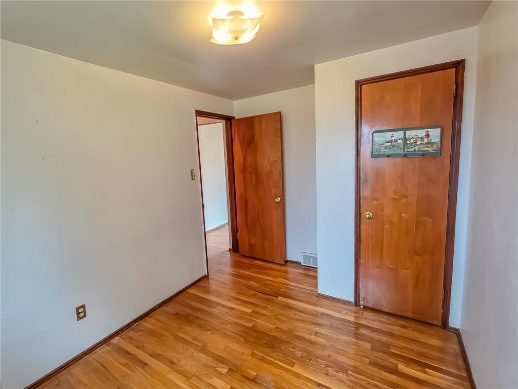 1494 Blossom Hill Road Pittsburgh, PA 15234 - Photo 21 of 40 a view of an empty room with wooden floor and a window