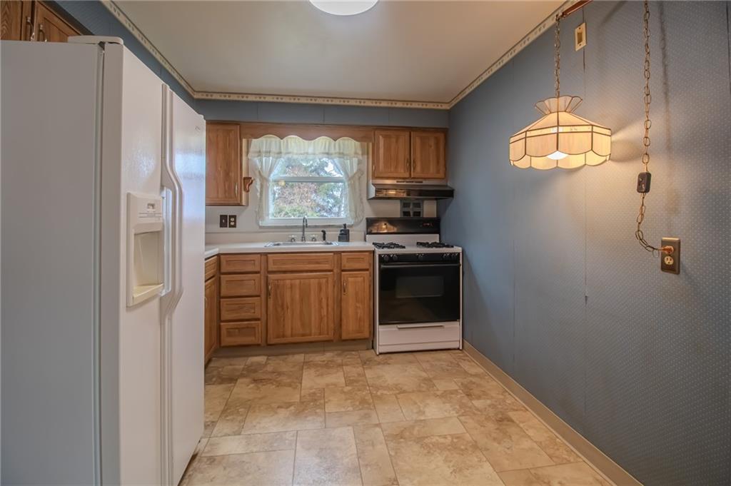 1494 Blossom Hill Road Pittsburgh, PA 15234 - Photo 22 of 40 a kitchen with a stove a sink and a window