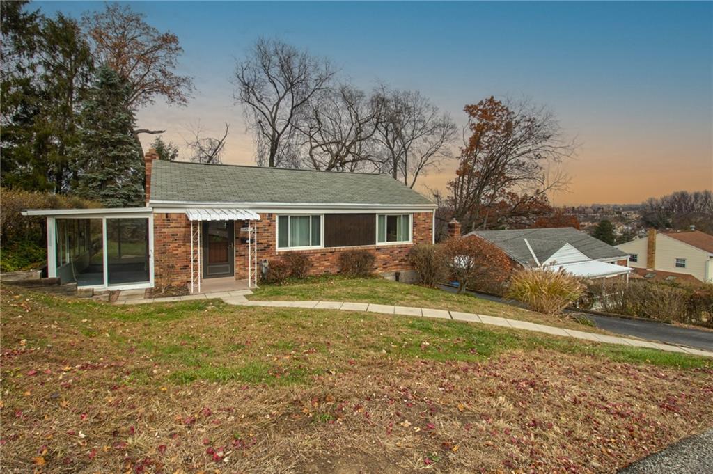 1494 Blossom Hill Road Pittsburgh, PA 15234 - Photo 5 of 40 a front view of a house with a yard