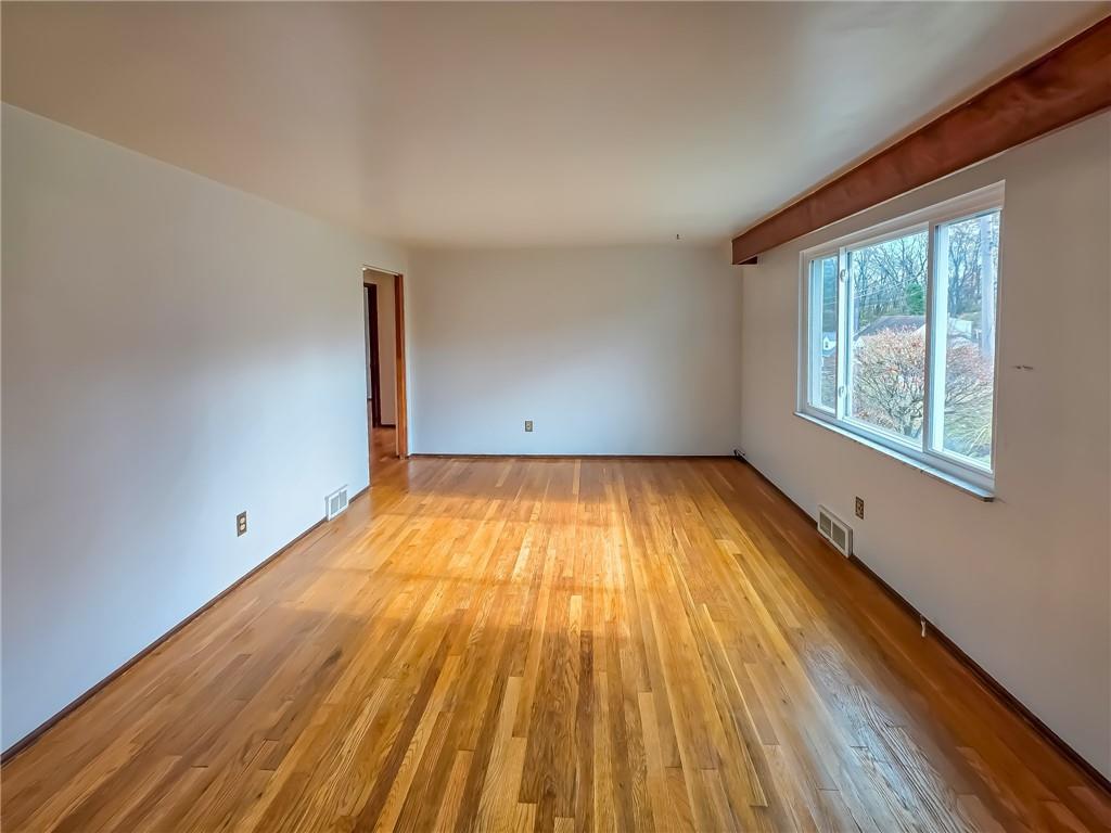 1494 Blossom Hill Road Pittsburgh, PA 15234 - Photo 10 of 40 an empty room with wooden floor and windows