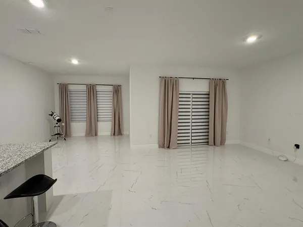 a view of an empty room with a window