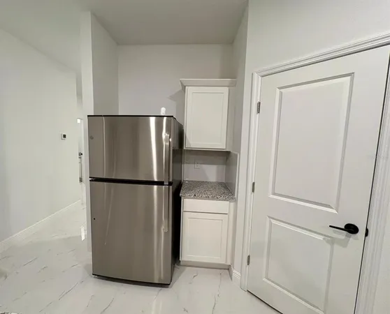 a white refrigerator freezer and a dishwasher in a kitchen