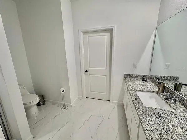 view of a bathroom with a sink a toilet and a tub