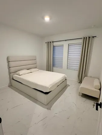 a bedroom with a bed and a chair