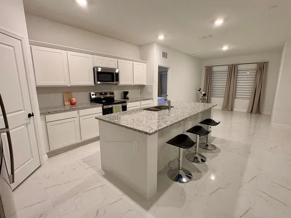 a kitchen with counter top space cabinets and appliances