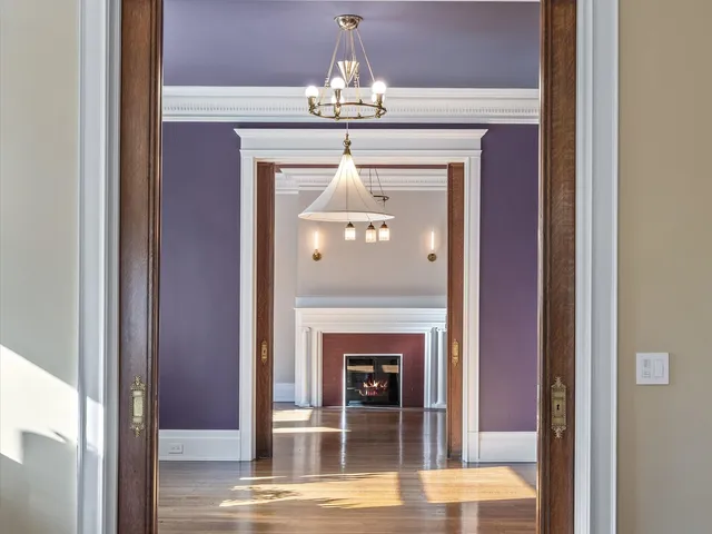 a bedroom with a bed mirror and a window