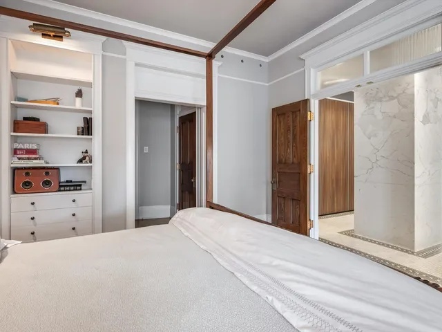 a view of a hallway with wooden floor and staircase