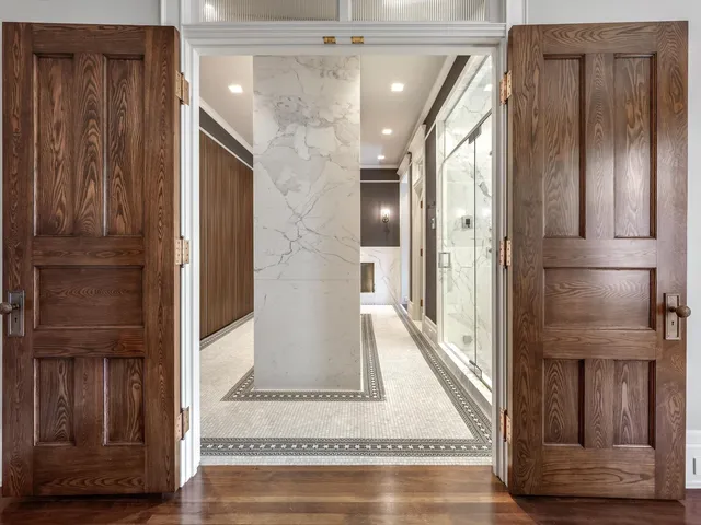 a view of a hallway with wooden floor and staircase