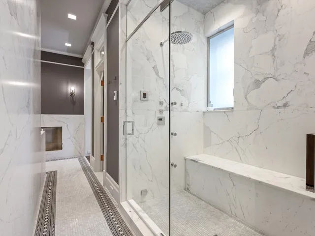 a spacious bathroom with a granite countertop sink and a mirror