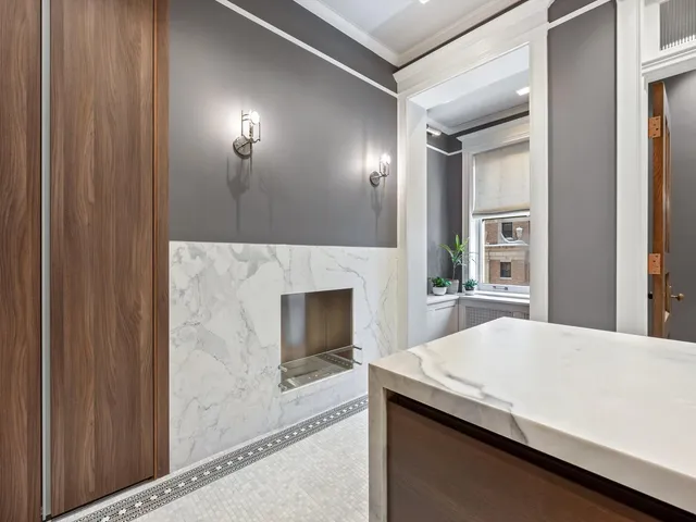 a kitchen with kitchen island a stove and a wooden floor