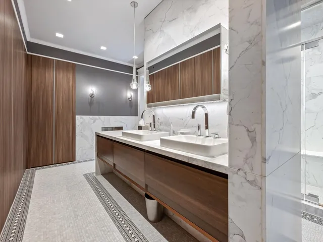 a large white kitchen with a sink a refrigerator and a stove