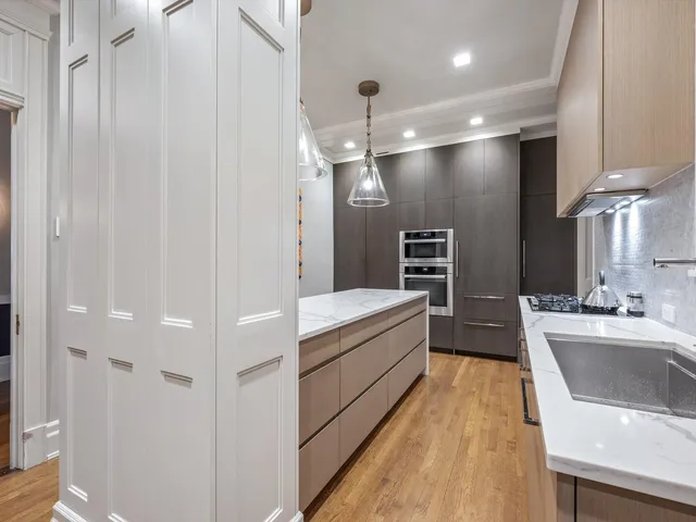 a view of a workspace with furniture and a air conditioner vent